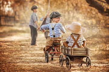 Boys playing in the street and ride a bike summer day