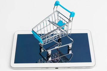 Empty grocery toy  shopping cart on a table