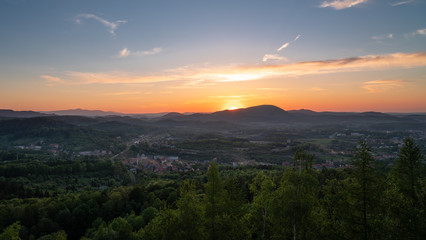 Panorama view of a city and summer sunset captured from a hill