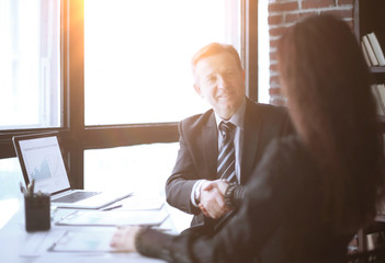 handshake financial partners sitting at their Desk