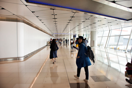 Chinese people and foreigners traveler walking in terminal of Hong Kong International Airport, Mainland China