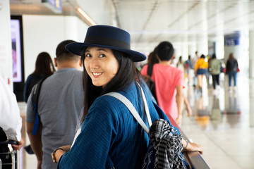 Travelers thai woman walking in terminal go to bus station at Hong Kong International Airport,...