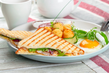 Club sandwich panini with ham, tomato, cheese and basil with cheese balls