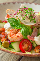 Fresh seafood salad served with prawns and greens