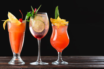 Alcoholic and non alcoholic cocktails on wooden table. Summer cold drinks