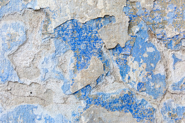 Old weathered blue plaster wall texture. Grunge background.