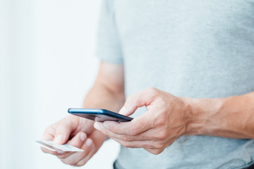 mobile payment and safe online transactions. digital finance and electronic operations. man holding...