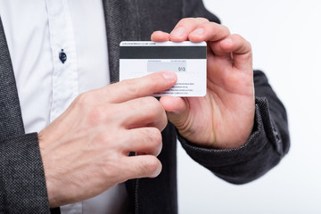 credit card CVV2 code. online payments security. man holding plastic card and pointing to number.