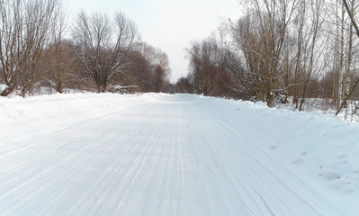 Winter road in the snow forest, aerial foto.