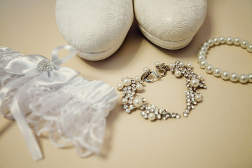 Wedding accessory bride. Stylish shoes, earrings, garter standing on white background. flat lay. top view. Marriage concept