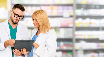 Pharmacist working with another pharmacist in the pharmacy. Healthcare and medical service.
