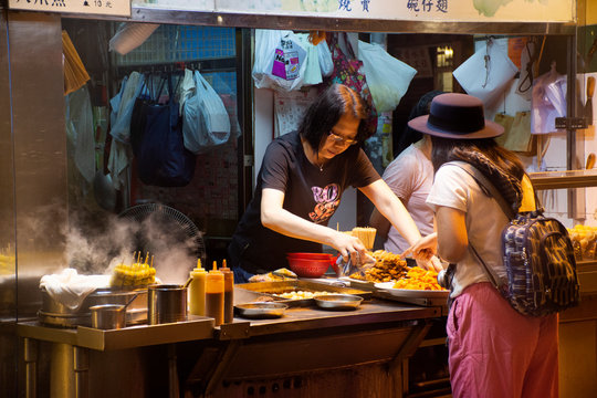 Travelers thai woman select and buy cuisine from Street Food in Hong Kong, China