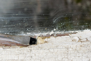 Removing glazing putty from old window. Home renovation close up image with copy space.