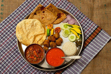 Authentic Maharashtrian lunch thali with Amras and poli, India.