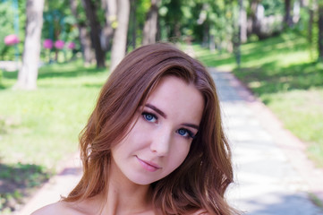 Fototapeta premium Young girl in a white dress in the park.