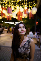 Fototapeta premium Young beautiful Asian woman thinking against scenic view of ligh