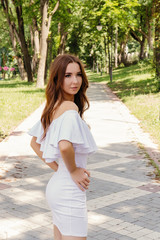 A girl in a white board in the park.