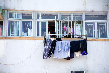 Lifestyle of Hong Kong people hanging dry clothes in the sun at outdoor of high building apartment in Hong Kong, China