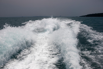 Marine travel ship tail photo. Stormy day seaside landscape. Motor boat trail with foam and splashing.