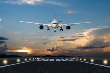 Door stickers Airplane Airplane landing in the evening with beautiful sunset background