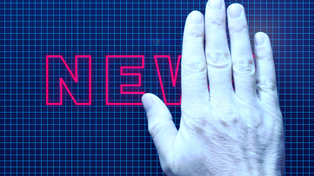 A businessman's hand erases the text: News
