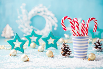 Candy cane sweets in a mug. Christmas and New Year background. Copy space.
