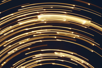 Blurred bright luminous golden stripes in the form of an arc from diode bulbs LED from Christmas...
