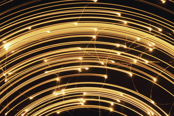 Blurred bright luminous golden stripes in the form of an arc from diode bulbs LED from Christmas...