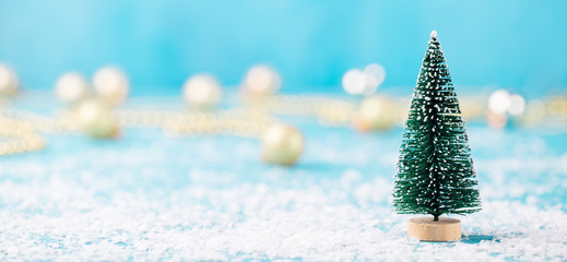Christmas, New Year blue background with snow and green eve ornaments. Copy space.