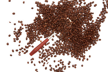Coffee beans and spoon arranged directly above white table background with copy space