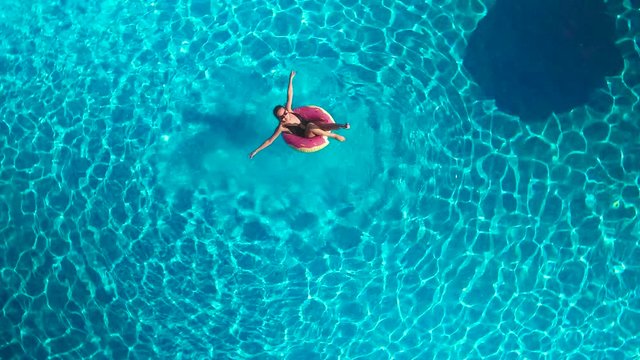 girl in the pool with an inflatable circle