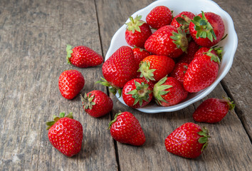 Ripe red strawberries on wooden table