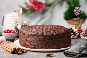 Christmas fruit cake, pudding on white plate. Copy space. Close up.