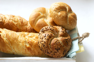 Kaiser wheat and rye flour buns with seeds, mini baguettes with ham and cheese, fresh bread.
