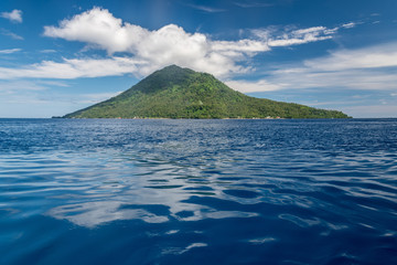 View of vulcano and island Manadotua close to town Manado in Celebes sea part of archipelago...