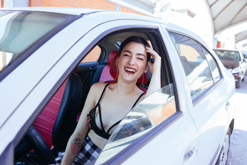 Fototapeta na wymiar sexy woman driving a white car