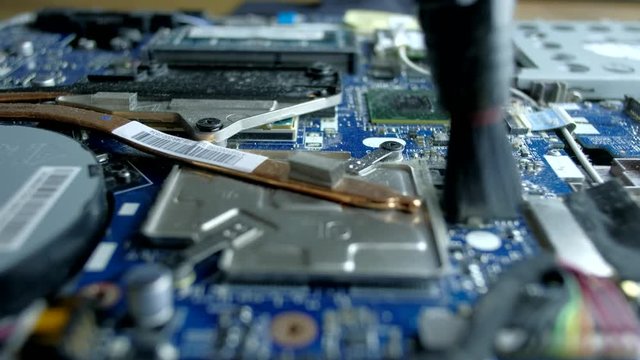 Computer Service. The serviceman cleans the interior of the laptop with dust and other dirt. 4k.