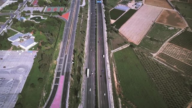 Aerial view of major highway traffic on a sunny day, Autopista del Mediterraneo, Spain