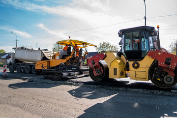 Heavy Vibration roller at asphalt pavement working on the new road construction site. Repairing.