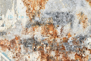 corroded sheet metal background with remains of posters