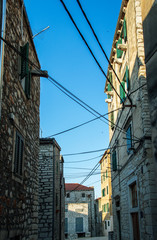 Wires against a deep blue sky. The chaos of cables in old town