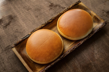 Burger buns with Golden crust on wooden background