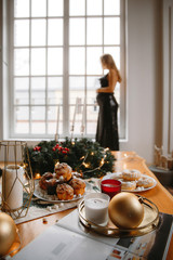 Beautiful Pregnant Woman In evening dress near the window