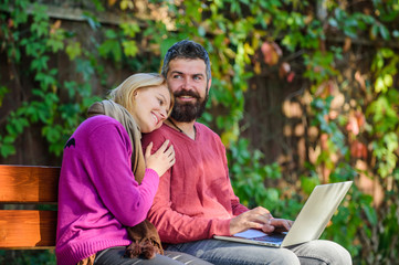 Couple in love notebook consume content. Internet surfing concept. Couple with laptop sit bench in park nature background. Surfing internet together. Family surfing internet for interesting content
