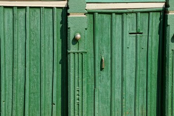 Fototapeta na wymiar green wooden texture of the boards on the old doors and the fence