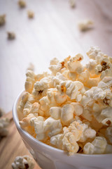 Salt popcorn on the wooden table, selective focus