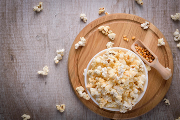 Salt popcorn on the wooden table, selective focus