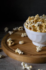 Air salty popcorn.A bowl of popcorn on a wooden table. Rustic style.