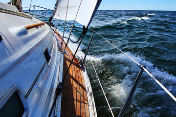 Sail boat gliding in open sea