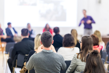 Business and entrepreneurship symposium. Speaker giving a talk at business meeting. Audience in...